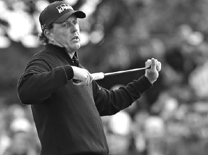 phil mickelson reacts after a missed eagle putt on the 16th green