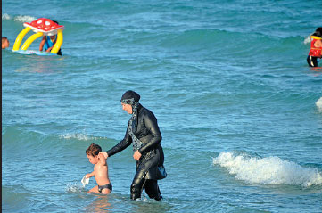 Burkini ban backed in France, dismissed in Italy