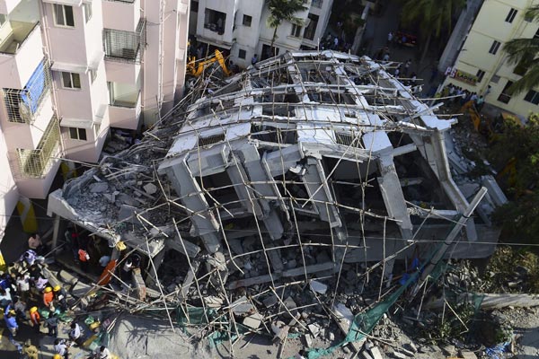 People Watch As Rescue Workers Try To Pull Out Victims