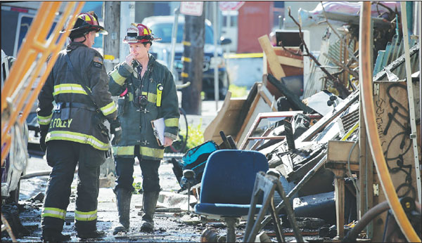 firefighters work at the scene of the blaze in the