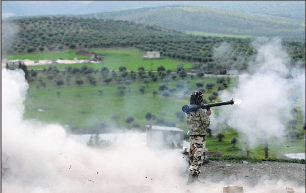 A Turkish Backed Free Syrian Army Fighter Fires A