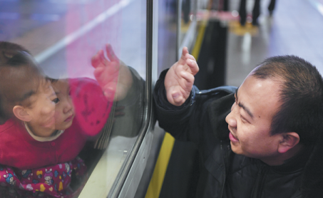 wang changfu right waves to his daughter at beijing railway station on