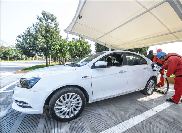 Employees Charge An Electic Car At An Expressway Service Area In