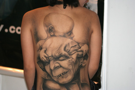 The tattoos on a girl's back during the Tattoo Show Convention China 2007 in 