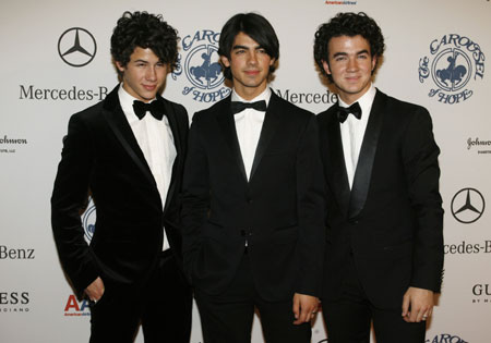 McPhee and other celebs attend Carousel of Hope Ball