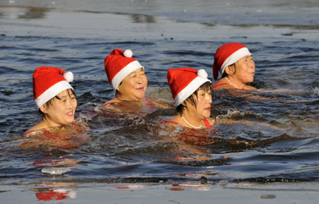 Women Winter Swimming Group in frozen lake