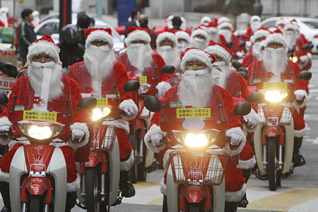 Postmen ride delivery motorcycles to deliver Christmas gifts