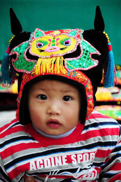 Traditional hand-made boots and hats with tiger images