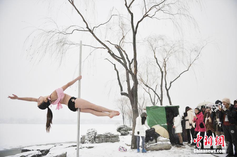 Pole dancers practice outside in cold winter