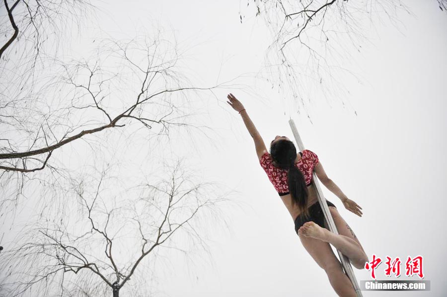 Pole dancers practice outside in cold winter