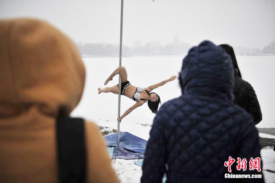 Pole dancers practice outside in cold winter