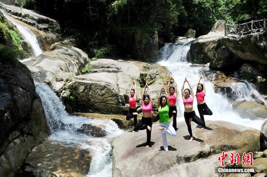 Yoga performed around waterfall in Jiangxi