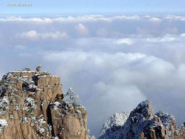 Tourists enjoy the scenery after snowfall in Huangshan Mountain