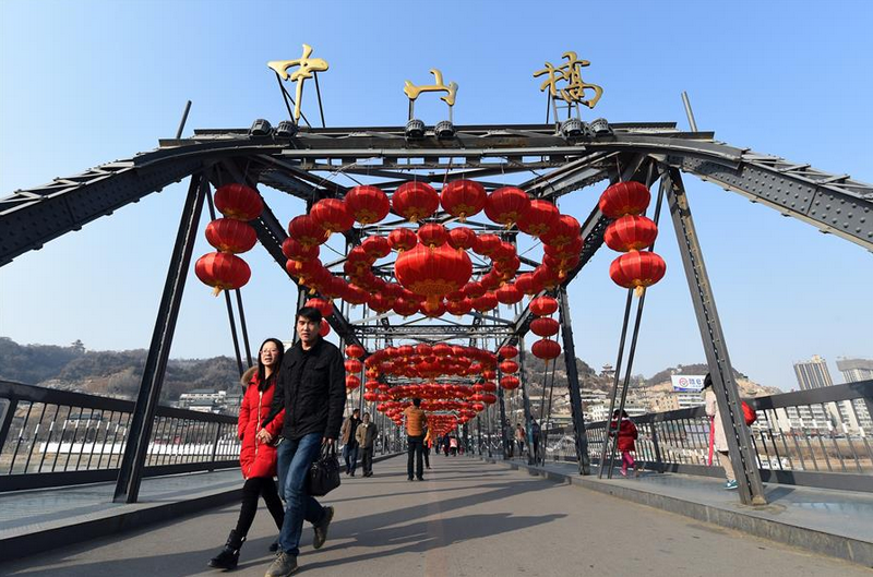 Red lanterns hung over century-old iron bridge to celebrate Spring Festival