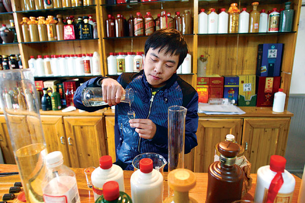 Fu Yao, 26, a professional blender of spirits and rising star in Moutai, displays a delicate touch at his lab as he combines the various ingredients to produce the distinctive taste. Zhang Wei / China Daily A town that wants people to drink to its success