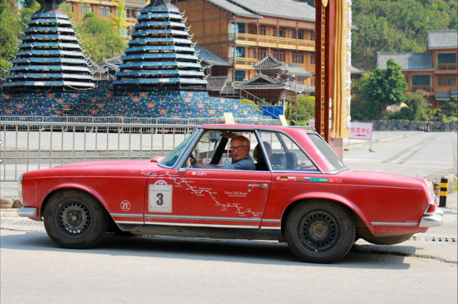 Fleet of vintage cars arrives in Zhaoxing Dong village, Guizhou province during cross-country trip
