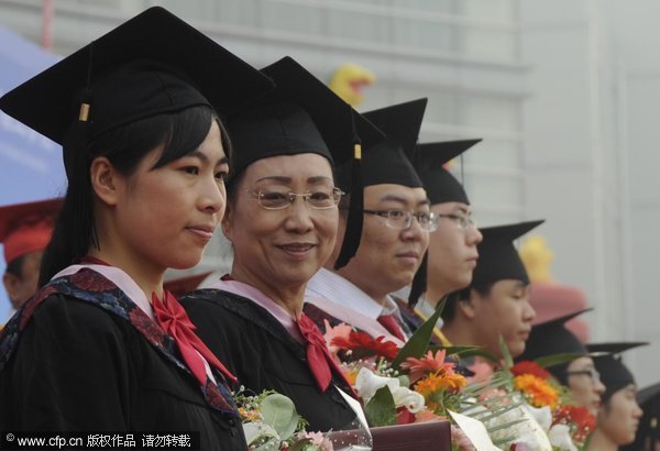 Tong Zhengguo, a 64-year-old graduate at Hebei United University, poses for a photo during her college graduation ceremony, June 5, 2012. Woman, 64, receives bachelor's degree