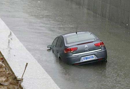 In a flash, car sinks in rainwater
