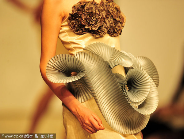 A model wears creations by graduates of Wuhan Textile University in Wuhan, Central China's Hubei province, May 18, 2011. About 50 selected garments from this year’s university graduates were presented in the show, with a diversity of styles from the elegant to the wild. A teacher said a graduation design usually took six months to complete and the finished product showed a student's understanding of nature, society, and life. Fashion graduates show what they’ve got