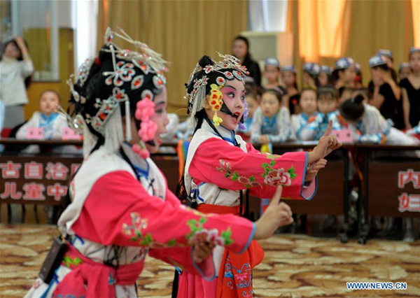 Children perform traditional Chinese Peking Opera