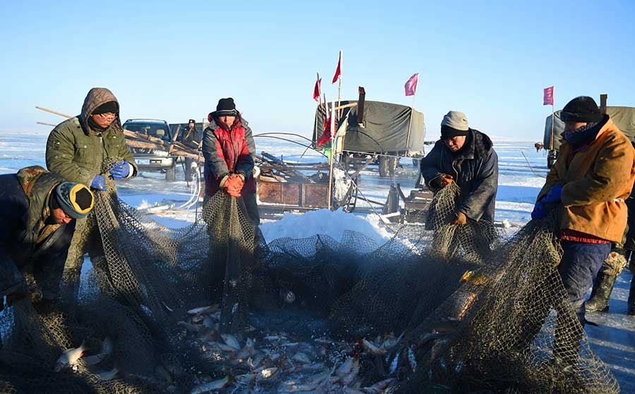 Winter fishing in ice-covered Hulun Lake in Inner Mongolia