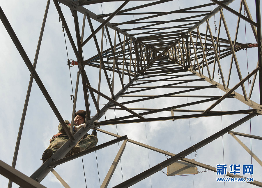 Electricians work on power lines in Wuhai