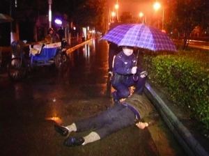 Police holds umbrella for a drunken man