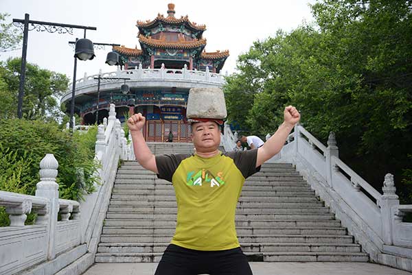 Man exercises with 40kg stone on his head 1 Jilin China