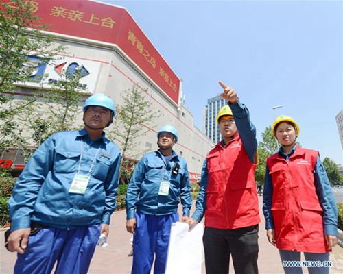 Volunteers seen on street in host city of 18th SCO Qingdao Summit