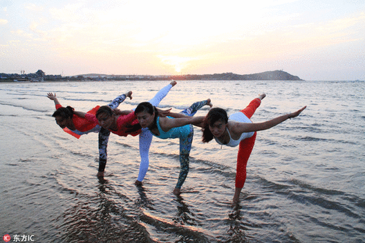 Fans practice yoga at seaside in E China