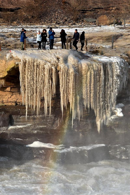 Silver thawing ice scenery of Hukou Waterfall in N China