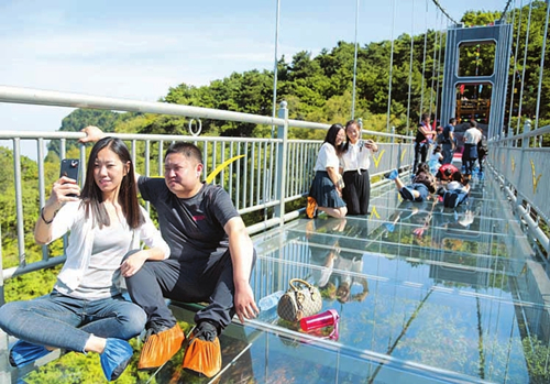 Hanging glass bridge attracts visitors to Wulao Mountain