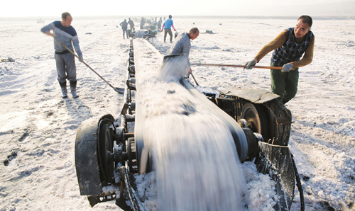 Workers harvest salt at Yanhu Lake