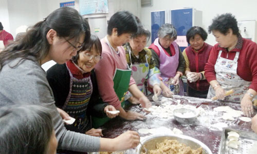 Volunteers make ravioli for the elderly people in