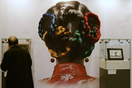 A visitor looks at a display object at an exhibition, on the history of the Olympic Games, in Hong Kong February 14, 2008. Hong Kong will hold the equestrian event of the Beijing 2008 Olympic Games in coming August. 