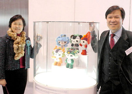 Visitors pose with Fuwa, the mascot for the Beijing Olympics, at an exhibition on the history of Olympic Games in Hong Kong February 14, 2008. Hong Kong will hold the equestrian event of the Beijing 2008 Olympic Games in coming August.