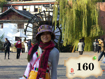 The photo is taken in LiJiang of Southwest China's Yunan Province. The dress is Tibetan style.