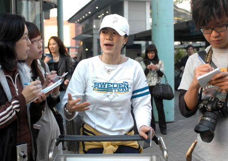 China's table tennis veteran Wang Nan answers questions raised by journalists as she arrives in Hong Kong, March 3, 2008. Wang will represent China in the Asian qualifiers for an Olympic berth. Four places in the host's team for the Games have already been taken by Ma Lin, Wang Hao, Zhang Yining and Guo Yue, leaving two spots up for grabs at the Asian Olympic qualifiers, which start on Thursday. [Xinhua]