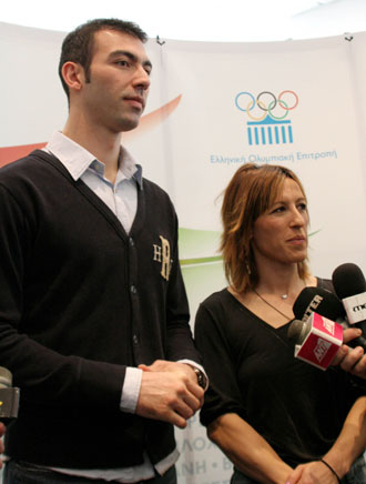 Olympic taekwondo silver medalist Alexandros Nikolaidis (L) and Olympic triple jump silver medalist Pigi Devetzi answer questions from journalists during a press conference in Athens, March 13, 2008. The Hellenic Olympic Committee announced Thursday that Nikolaidis will be the first torchbearer for Beijing Olympic Games, and Devetzi will be the last one who will light the Olympic Flame at the altar of the Panathenian Stadium on March 30, before handing over the flame to the Beijing Olympic Organizing Committee.