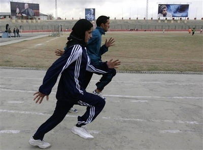 Mehbooba Ahadyar 19, an Olympic track star runs with Massoud Azizi 20, during there practice session at a Ghazi Stadium in Kabul, Afghanistan, Monday , March 10, 2008. Ahdyar is the only woman among four Afghans due to represent the war-torn country at August's Beijing Olympics and the slightly built 19-year-old 1,500 metre runner stands little chance of a medal. Competing, however, is more about pride and showing the world what Afghan women can do. Picture taken March 15, 2008. [Agencies]