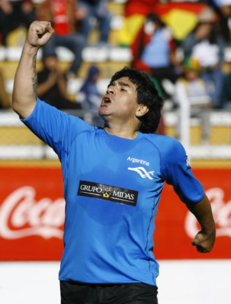 Former Argentine soccer star Diego Maradona celebrates after scoring a goal against Bolivian President Evo Morales' team during their friendly soccer match in La Paz in this March 17, 2008 file photo. Maradona could be the first runner to carry the Olympic torch when it arrives in Argentine capital Buenos Aires on April 11, if he is in Argentina, Xinhua released on Wednesday. 