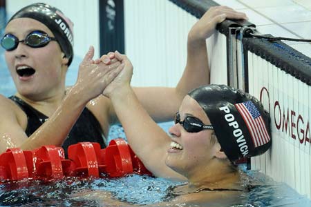 Erin Popovich(R) of the United States is congratulated after the S7 final of women's 400m freestyle during the Beijing 2008 Paralympic Games at the National Aquatics Center in Beijing, Sept. 11, 2008. Popovich claimed the title of the event and broke the Paralympic record with a time of 5 mins 17.41 secs.