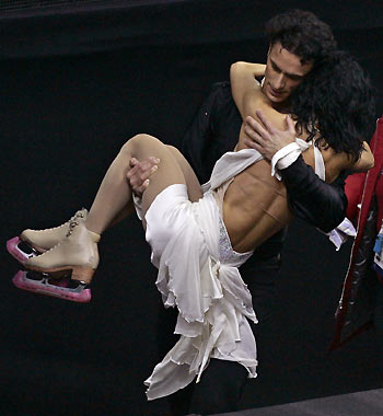Patrice Lauzon carries Marie-France Dubreuil from Canada after their performance in the original dance figure skating event at the Torino 2006 Winter Olympic Games. [Reuters]