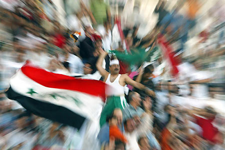 Iraqi soccer fans cheer as Iraq play against China in their AFC Asian Cup 2007 qualifier soccer match at Khalifa Bin Zayed Stadium in Al Ain, United Arab Emirates March 1, 2006. Iraq won 2-1. [Reuters]