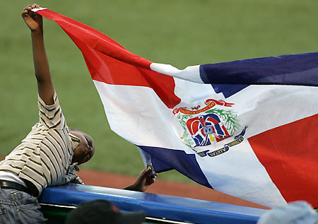 A child holds a Dominican Republic flag during the second round game against Cuba in the 2006 World Baseball Classic in San Juan, Puerto Rico, March 13, 2006. Dominican Republic won Cuba 7-3. [Reuters]