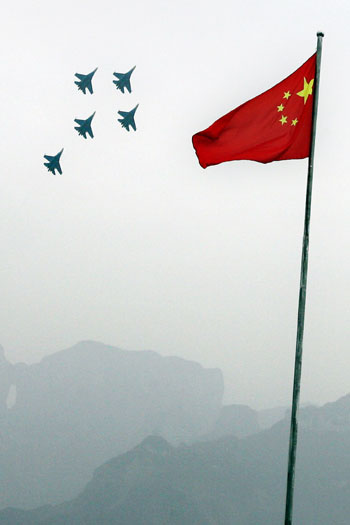 Su-27 fighter jets from the Russian Knights Aerobatic team perform near Tianmen Cave in Hunan Province's Tianmenshan National Park, China March 19, 2006. Russian pilots from the Russian Knights Aerobatic team performed their acrobatic skills in China's Hunan Province.