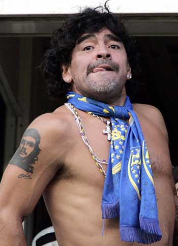 Former Argentine soccer player Diego Maradona celebrates after Boca Juniors tied their Argentine First Division soccer match against River Plate at the La Bombonera stadium in Buenos Aires March 26, 2006.