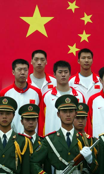 Basketball player Wang Zhizhi attends a flag-raising ceremony with his teammates at the Tiananmen Square in Beijing May 8, 2006. China's first NBA star Wang has earned a recall to the national team after four years in the wilderness following his refusal to play in the 2002 Asian Games. Wang paved the way for Chinese NBA players Yao Ming and Menk Barteer when he signed for the Dallas Mavericks in 2001, but the center was expelled from the national squad for opting out of representing China in Busan, South Korea four years ago. [Newsphoto]