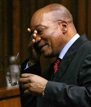 Former South African deputy-President Jacob Zuma reacts as he stands in the dock during the judgement in his trial for rape, in the Johannesburg High Court May 8, 2006. A South African judge on Monday acquitted Zuma of raping an HIV-positive family friend, ending a case that opened deep rifts in the ruling African National Congress. [Reuters]