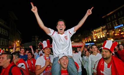 Sevilla's soccer fans celebrate their team's victory over Middlesbrough, in Market square in the centre of Eindhoven, the Netherlands, a few minutes after the UEFA Cup final between England's Middlesbrough and Spain's Sevilla at the PSV Stadium May 10, 2006. 